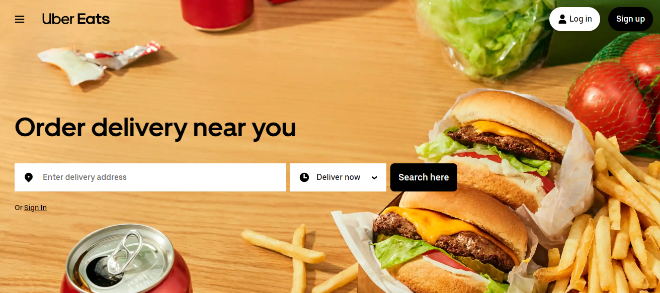 BFDA: Uber Eats home page showing burgers, fries, tomatoes, a can of soda, and cabbage